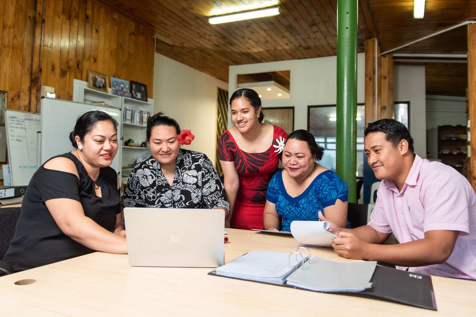 A team of Pacific business people reviewing finance options together